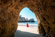 Traveler Woman Enjoying Alone The Beaches Of The Algarve, Portugal
