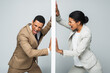 angry african american businessman and businesswoman pulling wall and screaming on grey, gender equality concept