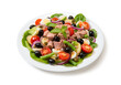 Nicoise salad with tuna, tomatoes, lettuce, olives in a white plate isolated on white background. Close-up.