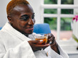 © Cultura Creative - Mature woman in white bathrobe enjoying tea