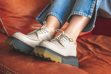 Wall Mural - Vintage luxury furniture and modern urban sneakers on teen girl in denim jeans. Casual fashion, footwear background photo