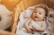 © Ananass - Portrait of a cute active baby lying in a crib smiling and looking at the camera. Copy space, Happy motherhood concept