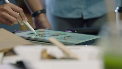 professional business people brainstorming graphic design team using tablet sharing ideas working together on creative project in development meeting close up hands