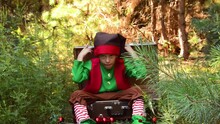 Little Boy Elf Sitting In A Suitcase For New Year And Christmas