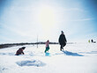 © Nektarstock - Family Playing in Snowy Field