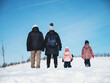 © Nektarstock - Rear view of family standing on snow slope
