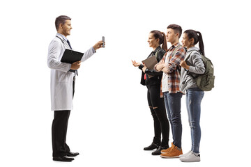 Wall Mural - Male doctor showing a mobile phone to a group of students