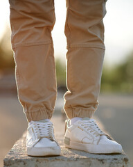 Feet man standing on concrete block. The concept of urban style.