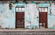 Vintage abandoned colonial building with plants growing out of the cracked walls, Antigua, Guatemala