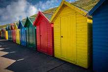 Photography Of Beach Changing Rooms Of Different Colors