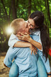 © Svitlana - Loving woman kissing boyfriend in sunny forest