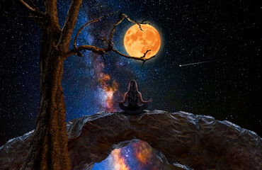 Wall Mural - woman meditating and observing the moon