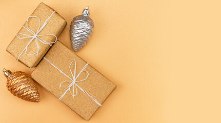 gifts in gold packaging, Christmas tree decorations - two cones gold and silver on a gold background