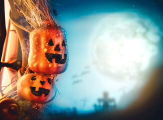 Halloween pumpkin and graveyard blurred background in the full moon night with copy space,halloween celebration concept