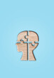Human head silhouette with a jigsaw piece cut out on the blue background, mental health concept.