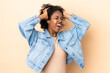 © luismolinero - Young African American woman isolated on beige background stressed overwhelmed