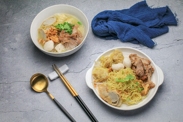 Wall Mural - Chinese egg noodle topping slice roasted pork, fish balls, shrimp balls and wontons. Asian food style.