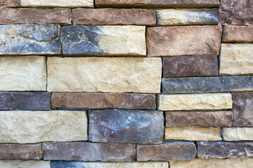 Wall Mural - close up view of new stone block structure building wall dark and light color cut stones