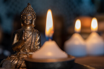 image in Buddhist temple next to candles