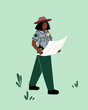 © Sophie Alp - Female forest ranger on duty in a national park. Park ranger walking on a trail patrolling nature reserve with map and radio.