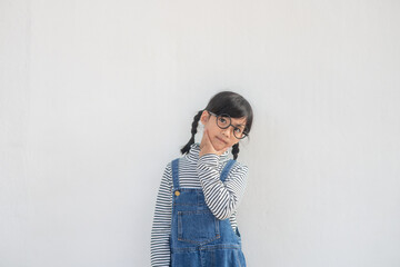 Cute Asian small girl wearing glasses and thinking