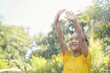 © FAMILY STOCK - Happy Asian little child girl having fun to play with the rain in the sunlight