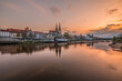 Regensburg during sunset with Danube river and cathedral and stone bridge at golden hour, Germany