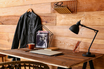 Poster - Modern workplace with laptop near wooden wall