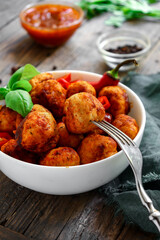 Wall Mural - Chicken meatballs in a plate. Meatballs and basil. Copyspace. Wooden background