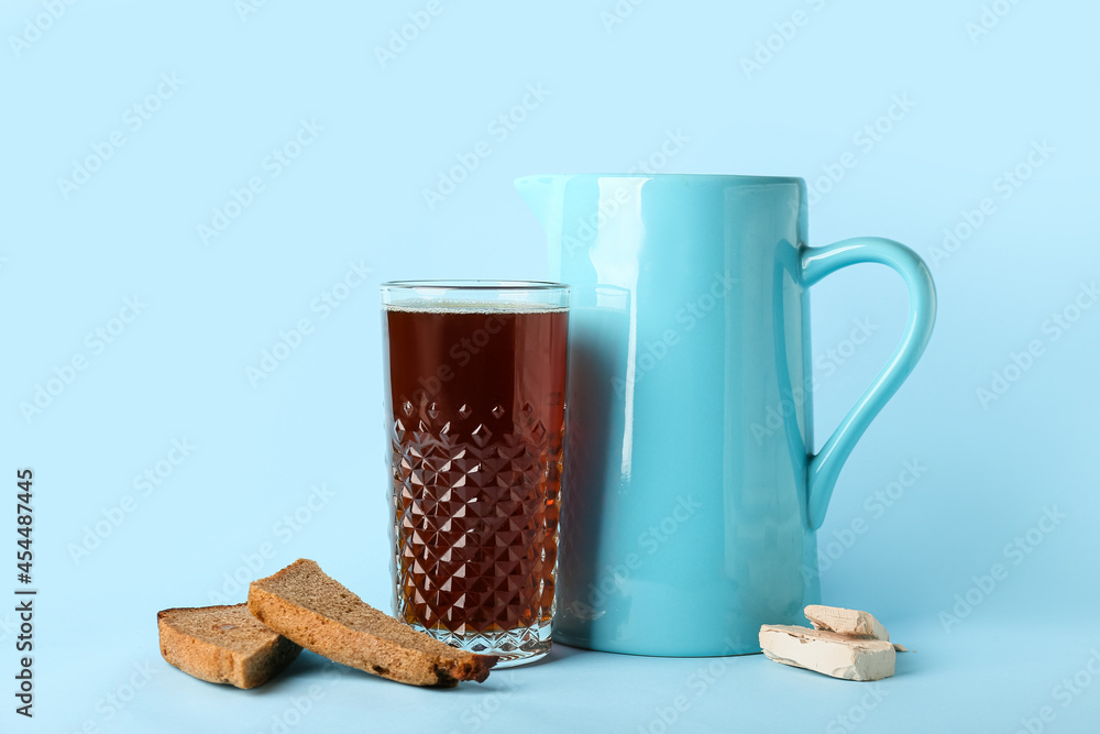 Glass of fresh kvass on color background