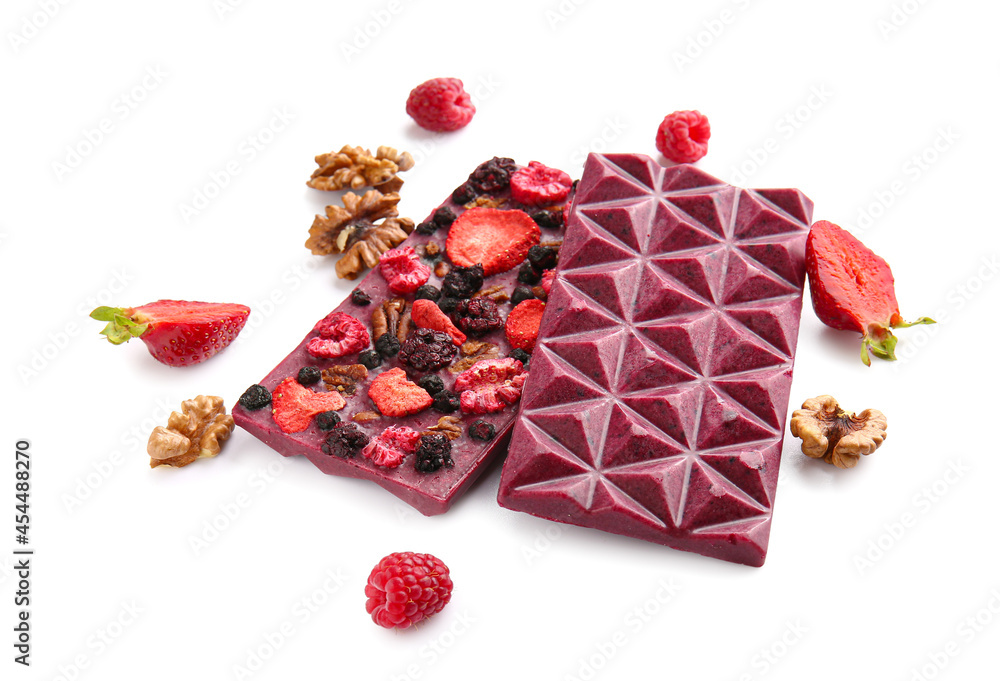 Handmade chocolate bars with fruits, berries and nuts on white background
