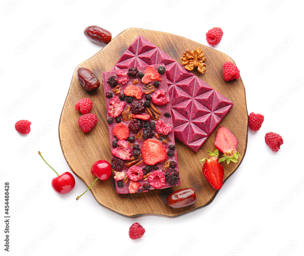 Handmade chocolate bars with fruits, berries and nuts on white background