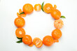 Circle of tasty mandarins on white background