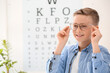 © Pixel-Shot - Little boy wearing glasses at ophthalmologist's office