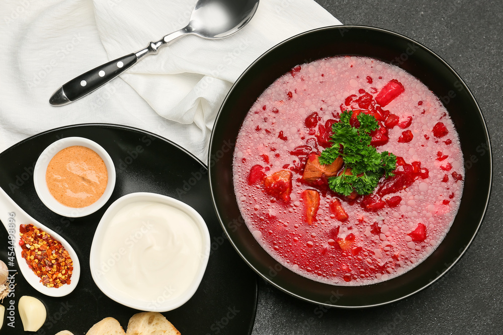 Composition with tasty borscht on dark background
