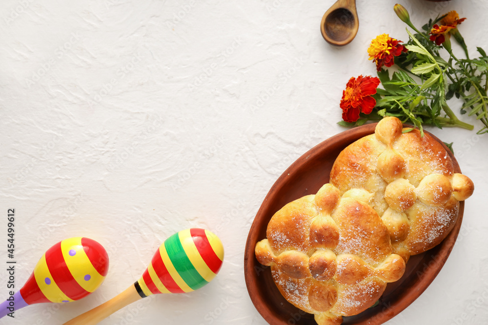 Bread of the dead and maracas on white background. Celebration of Mexico's Day of the Dead (El Dia de Muertos)
