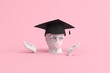 3d rendering of graduation cap on happy human sculpture.
