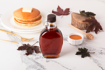 beautiful maple syrup in a bottle. maple leaves