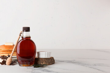 Wall Mural - Beautiful maple syrup in a bottle. Maple leaves
