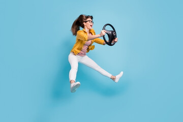 Sticker - Full body profile side photo of young woman happy smile jump hold steering-wheel ride car fast isolated over blue color background