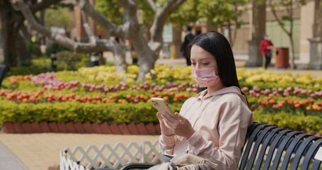 Sticker - Woman wear face mask and use of mobile phone at outdoor