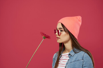 Wall Mural - gorgeous brunette in pink hat red flower luxury isolated background