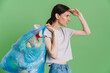 © Drobot Dean - Young brunette woman frowning while posing with plastic bags