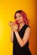 © Marina Chernivetskay - a girl of European nationality greedily looks at a piece of pizza wants to eat it on a yellow background with a place for the text