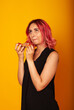 © Marina Chernivetskay - a girl of European nationality greedily looks at a piece of pizza wants to eat it on a yellow background with a place for the text