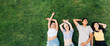 © Eugenio Marongiu - Group of young multiethnic friends outdoor lying grass smiling feeling free and relaxing - advertising copyspace banner