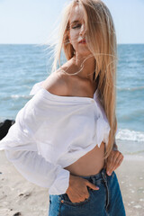 Poster - Beautiful young woman near sea on sunny day in summer