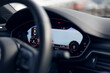 Glowing beautiful dashboard of a modern expensive car. The interior of the car. The foreground is blurred. Modern car interior details. Selective focus. The navigation map is visible on the display