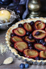 Canvas Print - Traditional round plum pie on the table.