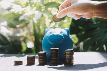 business people working at desk with piggy bank box.business finance saving and investment concept. hand put money coin into piggy bank for saving money wealth.